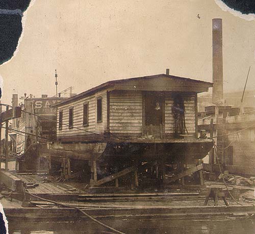 Scanned photo of houseboat in dry dock.