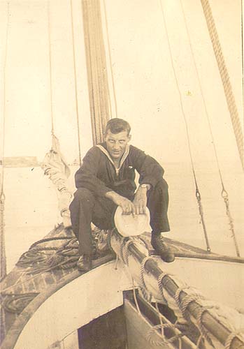 Scanned photo of Hugh Adams on a sailboat.