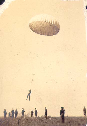 Scanned photo of a parachutist descending.