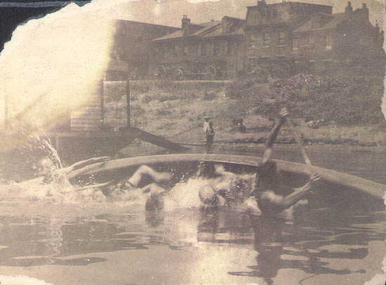 Scanned photo of canoe tipping over.