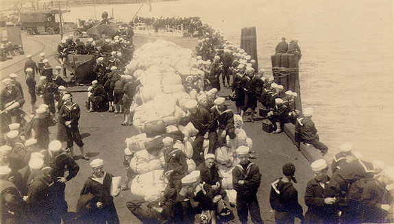 Scanned photo of sailors on wharf.