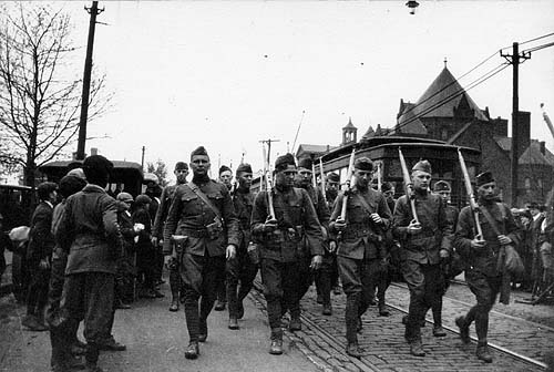 Scanned photo of troops marching on Fifth Avenue.