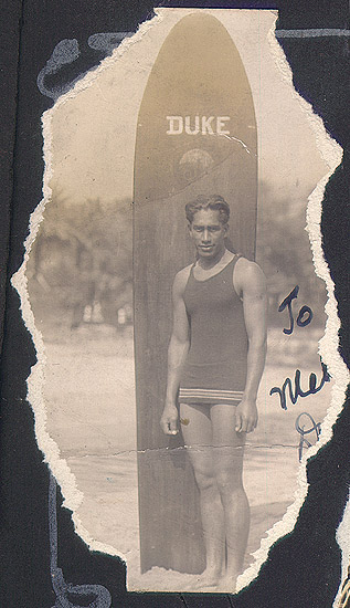 Scanned photo of young man and surfboard.