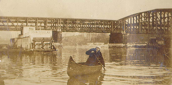 Scanned photo of man in a canoe.