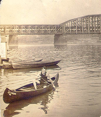 Scanned photo of Hugh Adams in canoe.