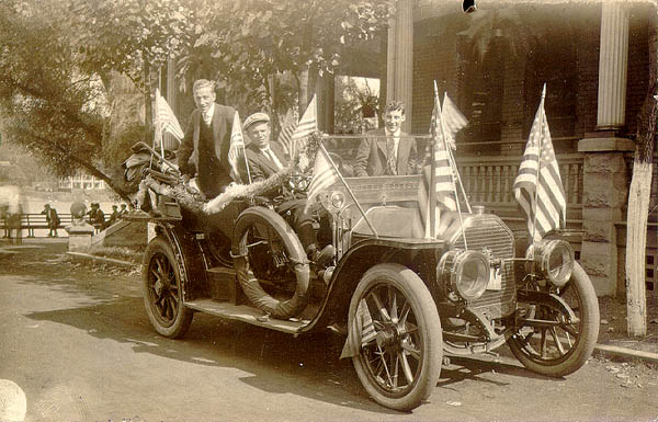 Scanned photo of flag-decorated automobile.