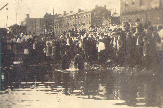 Scanned photo of a riverside baptism.