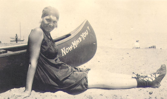 Scanned photo of a young woman lying on the beach.