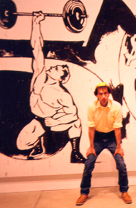 Scanned 
photograph of B.Chad standing in front of a muscleman by A. Warhol.